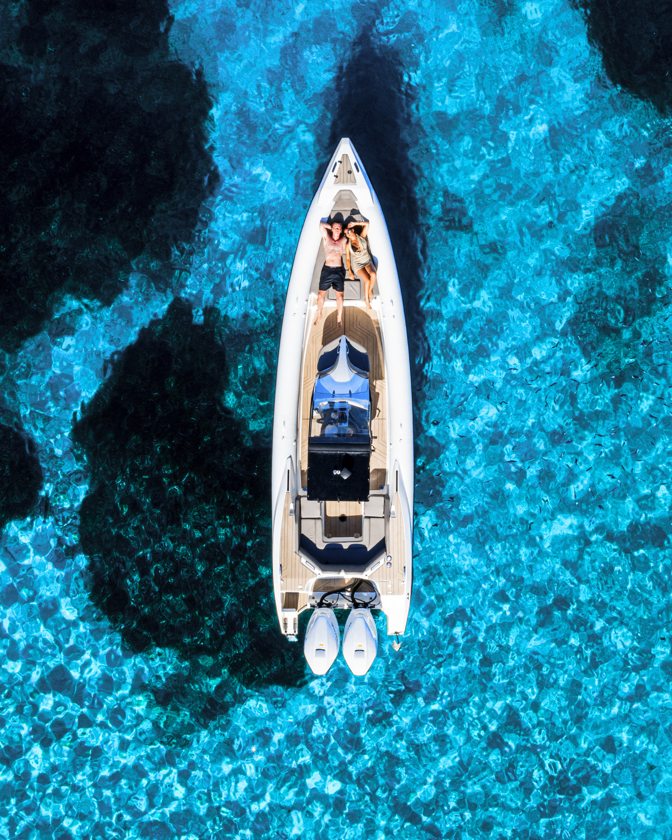 Top-down view of a boat on clear blue water | Oasis Boat rental Corfu d-marin